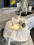 Scoop greek yogurt into mesh strainer