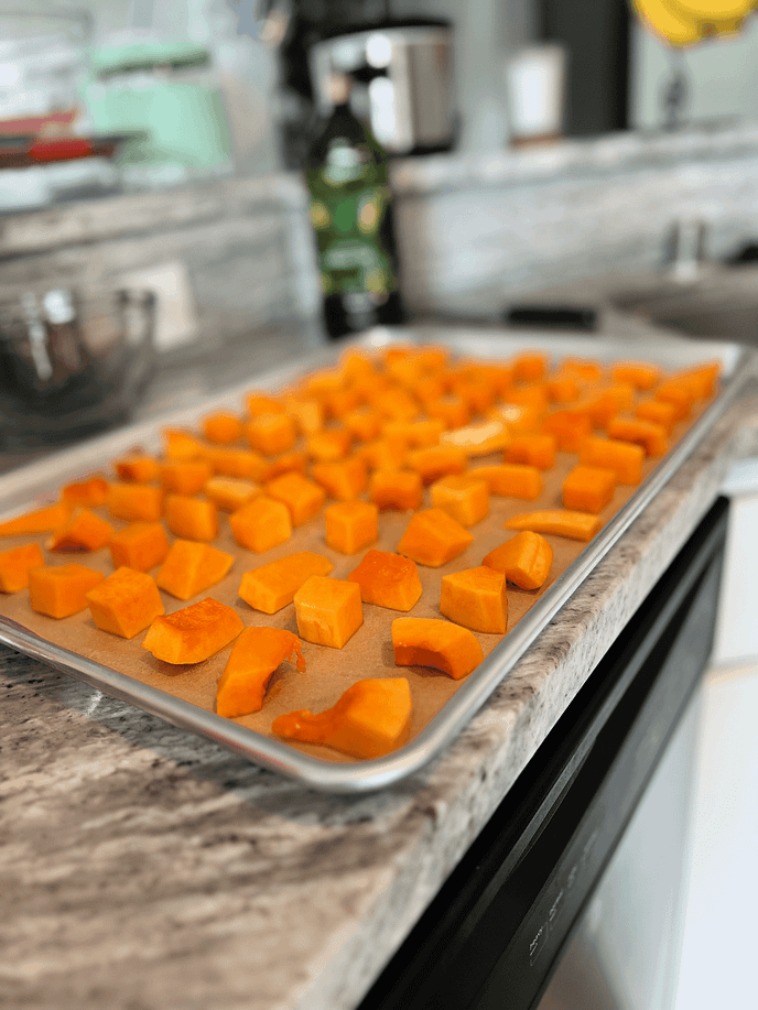 Line up butternut squash cubes in rows on baking sheet to roast